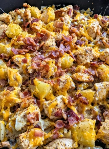 Delicious Blackstone Chicken Bacon Ranch Skillet with bacon and chicken pieces.