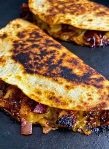 Delicious Blackstone Hot Honey BBQ Chicken Quesadillas with melted cheese and toppings