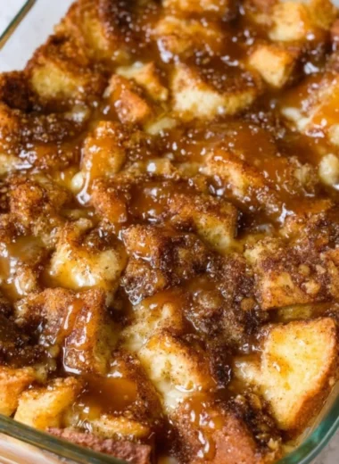 Delicious homemade bread pudding with spices and raisins in a white baking dish
