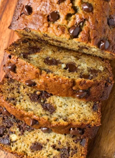 Moist chocolate chip banana bread sliced and served on a plate