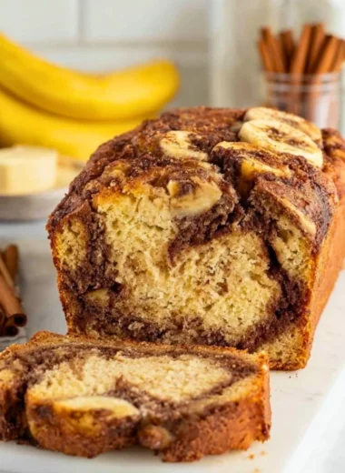 Cinnamon Swirl Banana Bread fresh out of the oven, sliced and ready to serve.