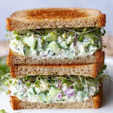 Fresh cucumber salad sandwiches served on a platter.