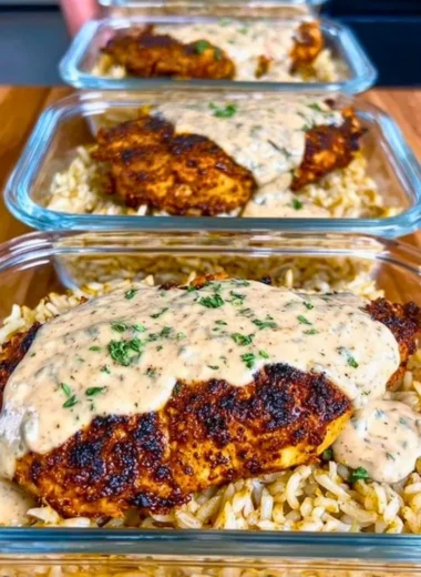 High Protein Creamy Cajun Chicken & Rice dish garnished with herbs