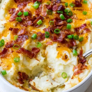 Delicious Loaded Mashed Potato Casserole topped with cheese and green onions