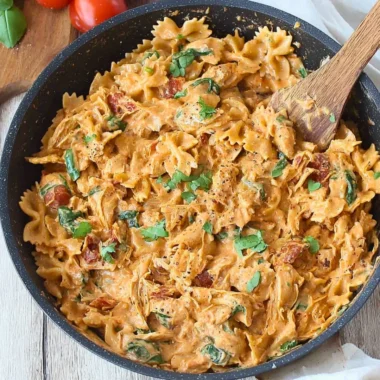 Plate of Marry Me Chicken Pasta topped with herbs and served with garlic bread