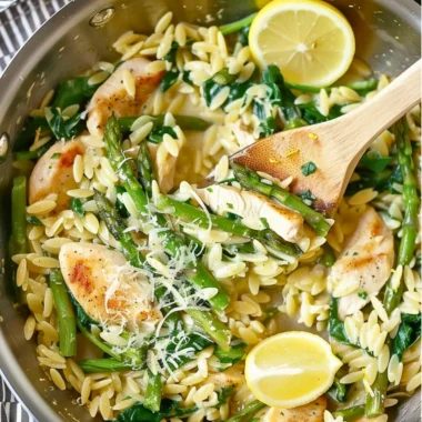 One Pot Lemon Chicken Orzo dish garnished with herbs and lemon slices