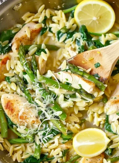 One Pot Lemon Chicken Orzo dish garnished with herbs and lemon slices