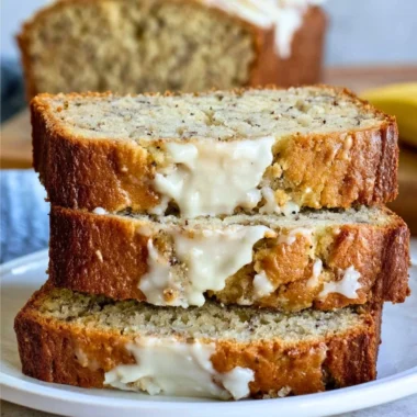 Loaf of perfect banana bread with slices showcasing its moist texture and rich flavor.