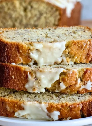 Loaf of perfect banana bread with slices showcasing its moist texture and rich flavor.