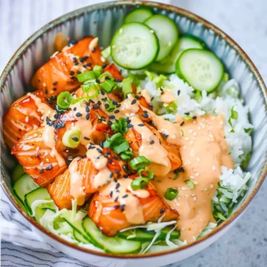 Delicious Spicy Salmon Bowl garnished with vegetables and sauces