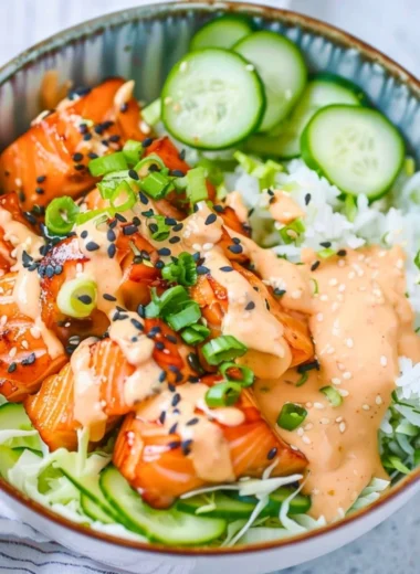 Delicious Spicy Salmon Bowl garnished with vegetables and sauces