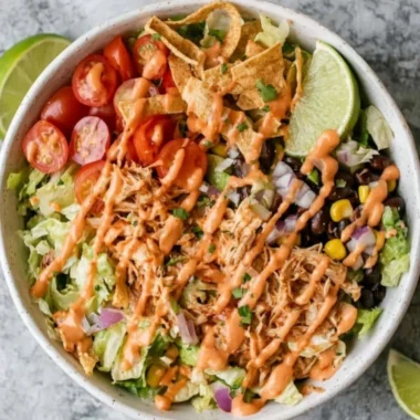 Delicious Taco Chicken Salad topped with fresh ingredients and spices.