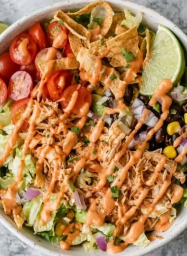 Delicious Taco Chicken Salad topped with fresh ingredients and spices.