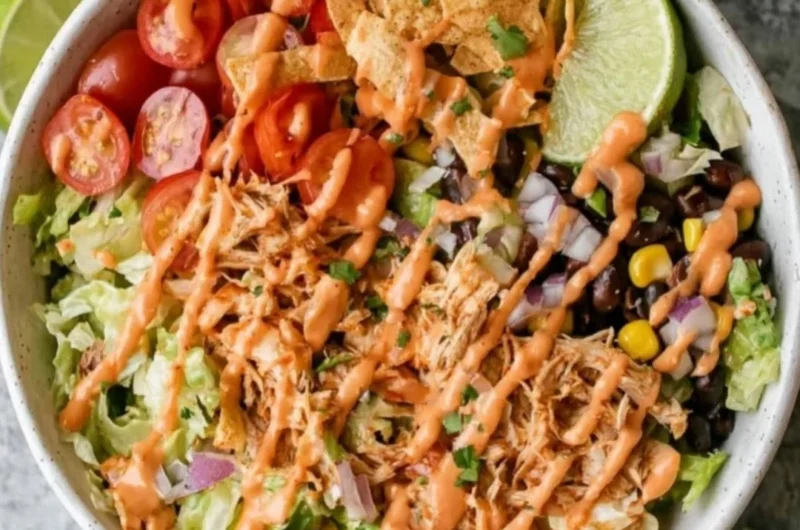 Delicious Taco Chicken Salad topped with fresh ingredients and spices.