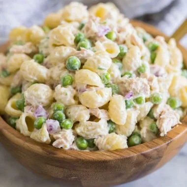 Bowl of Tuna Pasta Salad with fresh vegetables and dressing