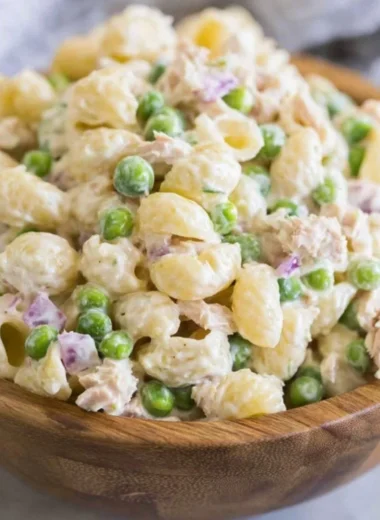 Bowl of Tuna Pasta Salad with fresh vegetables and dressing