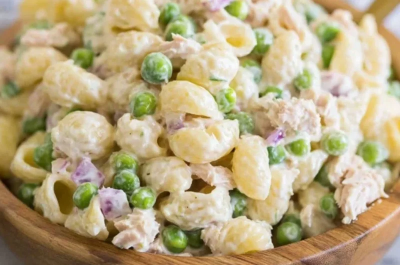 Bowl of Tuna Pasta Salad with fresh vegetables and dressing