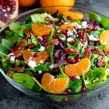 Vibrant winter salad with seasonal greens, fruits, and nuts