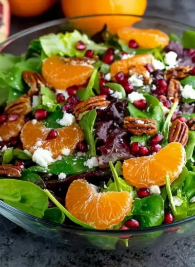 Vibrant winter salad with seasonal greens, fruits, and nuts