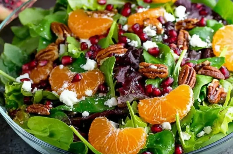 Vibrant winter salad with seasonal greens, fruits, and nuts