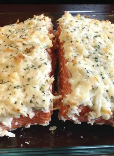 Baked salmon fillet with mayo, Parmesan and herb crust on a plate