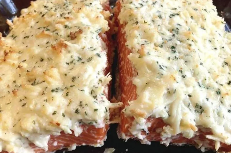 Baked salmon fillet with mayo, Parmesan and herb crust on a plate