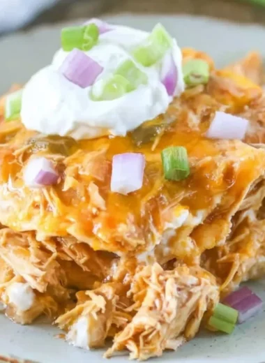Delicious chicken enchilada casserole served with toppings