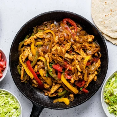 Colorful Chicken Fajitas served with tortillas and toppings