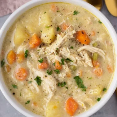 Delicious bowl of Chicken Pot Pie Soup garnished with herbs