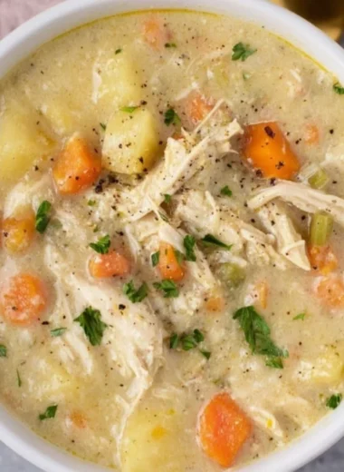 Delicious bowl of Chicken Pot Pie Soup garnished with herbs