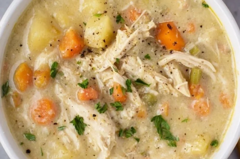 Delicious bowl of Chicken Pot Pie Soup garnished with herbs