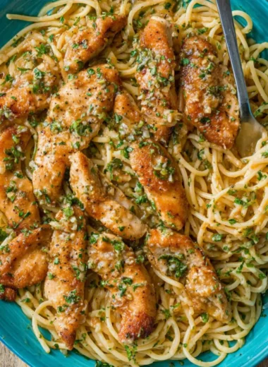 Delicious Chicken Scampi Pasta garnished with herbs and spices.