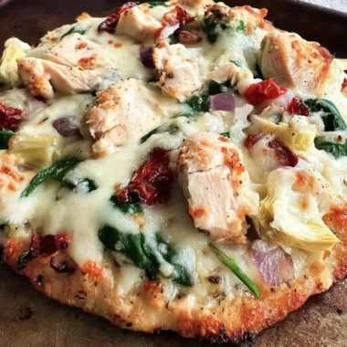 Delicious Chicken Spinach Artichoke Pizza topped with fresh ingredients.