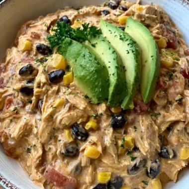 Crock Pot Fiesta Chicken in a bowl with colorful ingredients