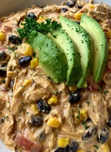 Crock Pot Fiesta Chicken in a bowl with colorful ingredients