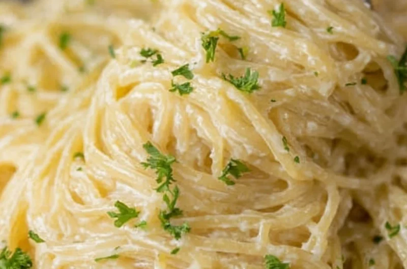 A bowl of creamy Garlic Parmesan Pasta garnished with parsley and grated cheese