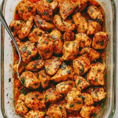 Juicy oven baked chicken bites on a plate, garnished and ready to serve