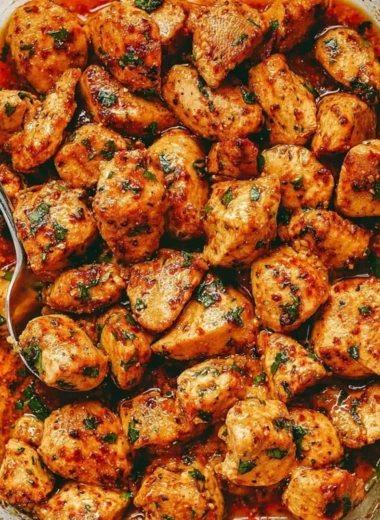Juicy oven baked chicken bites on a plate, garnished and ready to serve
