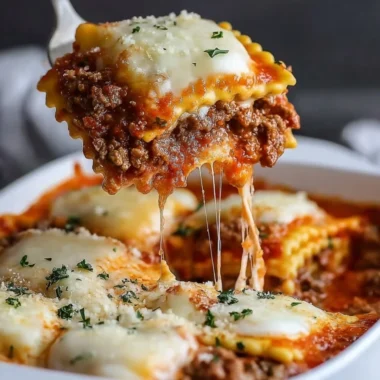 Delicious Million Dollar Ravioli Casserole topped with cheese and herbs