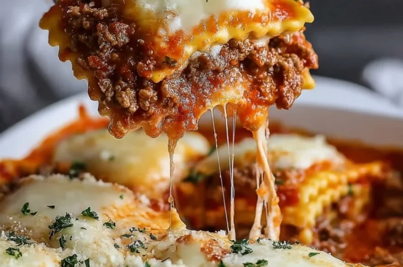 Delicious Million Dollar Ravioli Casserole topped with cheese and herbs
