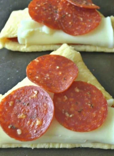 Homemade Pizza Roll-Ups with melted cheese and pepperoni in a golden crust