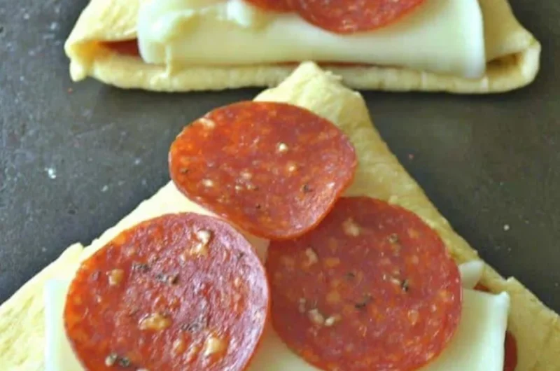 Homemade Pizza Roll-Ups with melted cheese and pepperoni in a golden crust
