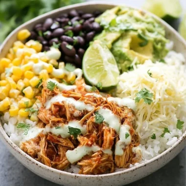 Slow cooker chicken burrito bowl with fresh ingredients and vibrant toppings
