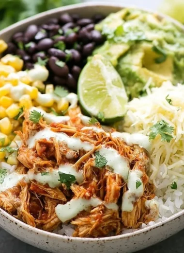 Slow cooker chicken burrito bowl with fresh ingredients and vibrant toppings