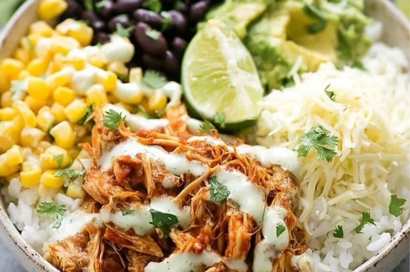 Slow cooker chicken burrito bowl with fresh ingredients and vibrant toppings