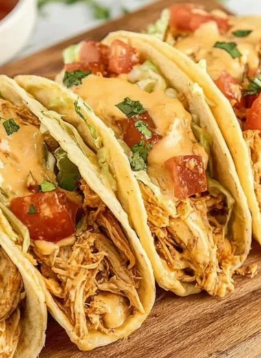 Delicious slow cooker queso chicken tacos topped with fresh ingredients