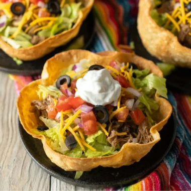 Colorful taco salad bowl with fresh vegetables and toppings