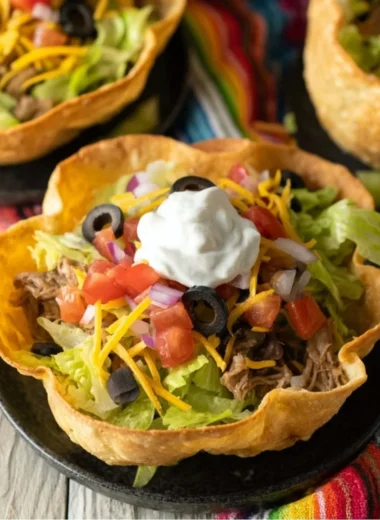 Colorful taco salad bowl with fresh vegetables and toppings