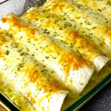 Delicious white chicken enchiladas topped with creamy sauce and cheese