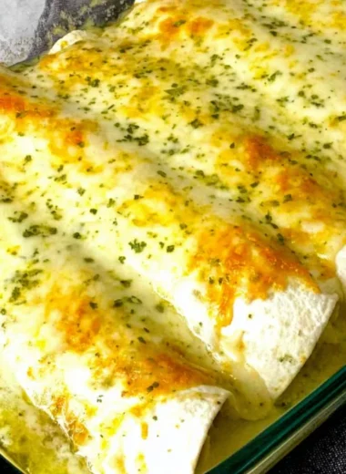 Delicious white chicken enchiladas topped with creamy sauce and cheese